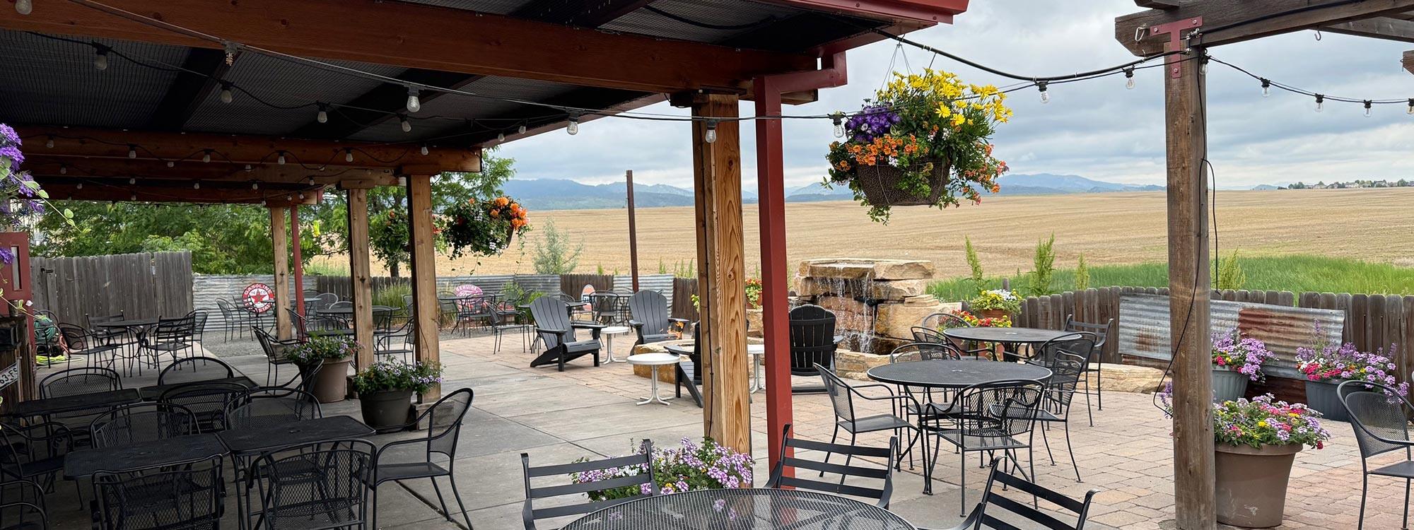 Covered patio with string lights looking west to the foothills